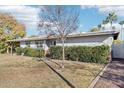 One-story house with mature shrubs and grassy front yard at 4601 N 75Th St, Scottsdale, AZ 85251