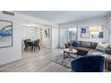 Open living room with gray sectional sofa and dining area at 6120 N 79Th St, Scottsdale, AZ 85250