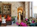 Stone hallway with arched entryways and unique decor at 66 Biltmore Est, Phoenix, AZ 85016