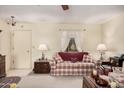 Living room with a plaid couch and charming, country-style decor at 9245 N 109Th Dr, Sun City, AZ 85351