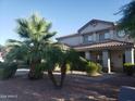 Two-story house with desert landscaping and a large palm tree in the front yard at 11432 E Quicksilver Ave, Mesa, AZ 85212