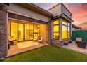 Relaxing backyard patio with seating area and grassy lawn at 12411 E Troon Vista Dr, Scottsdale, AZ 85255