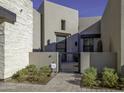 Contemporary home exterior with stone accents and a gated entry at 13767 N Prospect Trl, Fountain Hills, AZ 85268