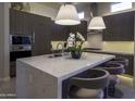 Sleek kitchen island with quartz countertops and modern pendant lighting at 13767 N Prospect Trl, Fountain Hills, AZ 85268