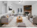 Bright living room with fireplace, wood accent wall, and comfy seating at 1433 E Kerry Ln, Phoenix, AZ 85024