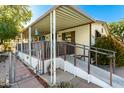 Mobile home with covered porch and ramp access at 1471 E 22Nd Ave, Apache Junction, AZ 85119