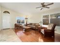 Living room with hardwood floors, comfortable seating, and large windows at 17713 N Larkspur Ln, Surprise, AZ 85374