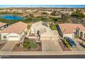 Stunning aerial view showcasing a house near a golf course and pond at 18265 N 116Th Dr, Surprise, AZ 85378