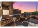 Inviting patio area with fire pit and seating, perfect for outdoor relaxation at 18265 N 116Th Dr, Surprise, AZ 85378