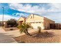 Tan house with a two-car garage and palm trees in front at 1964 S Marble St, Gilbert, AZ 85295