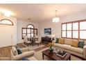 Bright living room with hardwood floors, beige couch, and dining area at 1964 S Marble St, Gilbert, AZ 85295