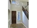 Bright entryway with hardwood floors, dark wood door and modern chandelier at 23306 N 40Th Pl, Phoenix, AZ 85050