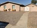 Gravel front yard with walkway to gated entry of home at 2348 W Laurel Ln, Phoenix, AZ 85029