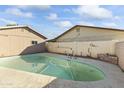 Kidney shaped swimming pool in the backyard of the home at 2348 W Laurel Ln, Phoenix, AZ 85029