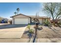 House with a two-car garage and mature trees in front at 3343 E Anderson Dr, Phoenix, AZ 85032