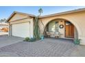 Inviting front entry with brick pavers and wooden door at 3343 E Anderson Dr, Phoenix, AZ 85032