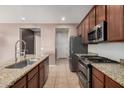 Modern kitchen with granite countertops and stainless steel appliances at 3667 S 185Th Dr, Goodyear, AZ 85338