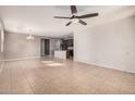 Spacious living room with tile floors and a ceiling fan at 3667 S 185Th Dr, Goodyear, AZ 85338