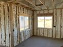 Interior of a new construction home showing framing and insulation in a room at 3730 N Maya Rd, Eloy, AZ 85131