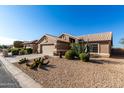 Tan house with cacti and gravel landscaping at 3832 N 162Nd Ln, Goodyear, AZ 85395