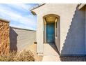 Inviting exterior with a teal door and walkway at 40634 W Hillman Dr, Maricopa, AZ 85138