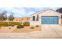 Charming house with a blue garage door and landscaped yard at 40634 W Hillman Dr, Maricopa, AZ 85138