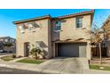 Tan two-story home with gray garage and landscaping at 4124 E Toledo St, Gilbert, AZ 85295