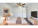 Large main bedroom with a wood bed frame and plenty of closet space at 4511 W Cavalier Dr, Glendale, AZ 85301