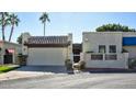 Front view of a charming home with a Spanish-style facade and attached garage at 4605 E Valley View Dr, Phoenix, AZ 85044