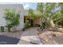 Front exterior showcasing a walkway to the entrance and beautiful desert landscaping at 5101 N Casa Blanca Dr # 301, Paradise Valley, AZ 85253