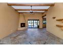 Living room with tile floors, fireplace, and sliding glass doors to backyard at 5743 E Windstone Trl, Cave Creek, AZ 85331