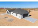 Contemporary home with two-car garage and desert landscape at 57968 W Fulcar Rd, Maricopa, AZ 85139