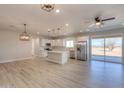 Modern kitchen with white cabinets, stainless steel appliances, and an island at 57968 W Fulcar Rd, Maricopa, AZ 85139