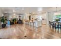 Open concept kitchen with island, white cabinets, and hardwood floors at 5801 E Exeter Blvd, Phoenix, AZ 85018