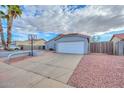 House exterior with a large driveway, basketball hoop, and desert landscaping at 6339 W Ironwood W Dr, Glendale, AZ 85302