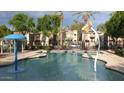 Community pool with water features and surrounding patio at 7844 W Bonitos Dr, Phoenix, AZ 85035