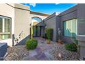 A charming courtyard entry with a stone path and drought-tolerant landscaping at 7878 E Gainey Ranch Rd # 3, Scottsdale, AZ 85258