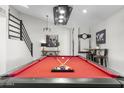 Game room features a pool table, bar-height seating, and artwork at 8025 E Redwing Rd, Scottsdale, AZ 85250