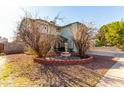 Two-story house with a fountain and landscaping in the front yard at 8631 W Monte Vista Rd, Phoenix, AZ 85037