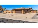 Tan brick home with a brown garage door and a mailbox at 9714 W Rodeo Ct, Sun City, AZ 85373