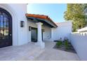 Inviting front patio with a decorative door, columns, and tile flooring at 9789 E Cinnabar Ave, Scottsdale, AZ 85258