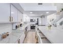Clean, modern kitchen with white cabinets and marble countertops at 11020 W Lane Ave, Glendale, AZ 85307