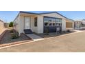 Mobile home with carport and nicely landscaped front yard at 11596 W Sierra Dawn Blvd # 109, Surprise, AZ 85378