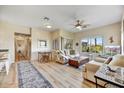 Bright living room with light colored sofas and hardwood floors at 12050 N Panorama Dr # 208, Fountain Hills, AZ 85268