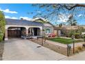 Charming bungalow with a well-manicured lawn and a carport at 1233 E Monte Vista Rd, Phoenix, AZ 85006