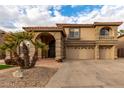 Two-story home with three-car garage and desert landscaping at 13332 W Palo Verde Dr, Litchfield Park, AZ 85340