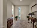 Bright and airy foyer with tile flooring and a console table at 1520 W Sonoqui Blvd, San Tan Valley, AZ 85140