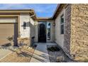 Elegant entryway with an ornate black door and stone facade at 1520 W Sonoqui Blvd, San Tan Valley, AZ 85140