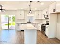 Modern kitchen with white shaker cabinets, quartz countertops, and stainless steel appliances at 1539 E 3Rd St, Mesa, AZ 85203