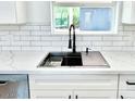 Modern kitchen features a farmhouse sink and sleek black faucet at 1539 E 3Rd St, Mesa, AZ 85203